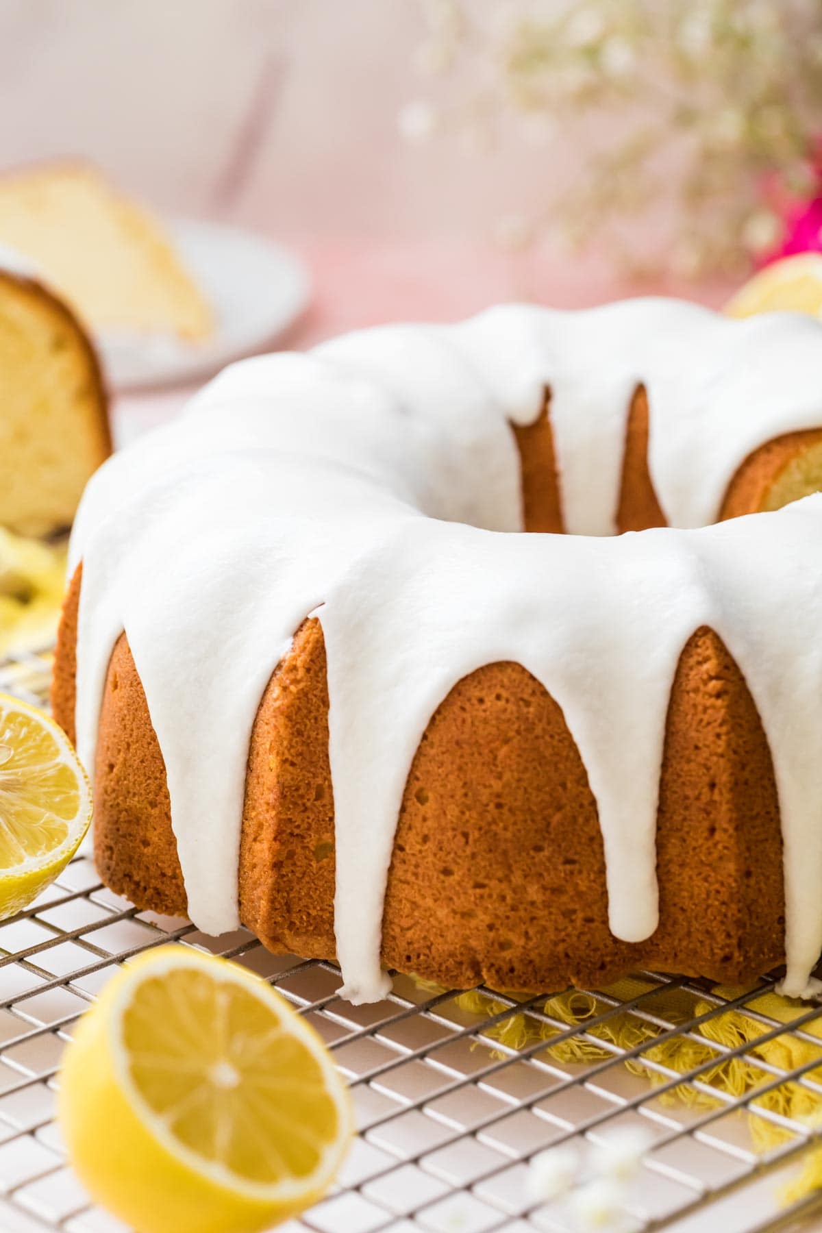 Lemon pound cake iced sitting on a cooling rack.