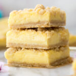 Three lemon crumb bars stacked on top of each other.