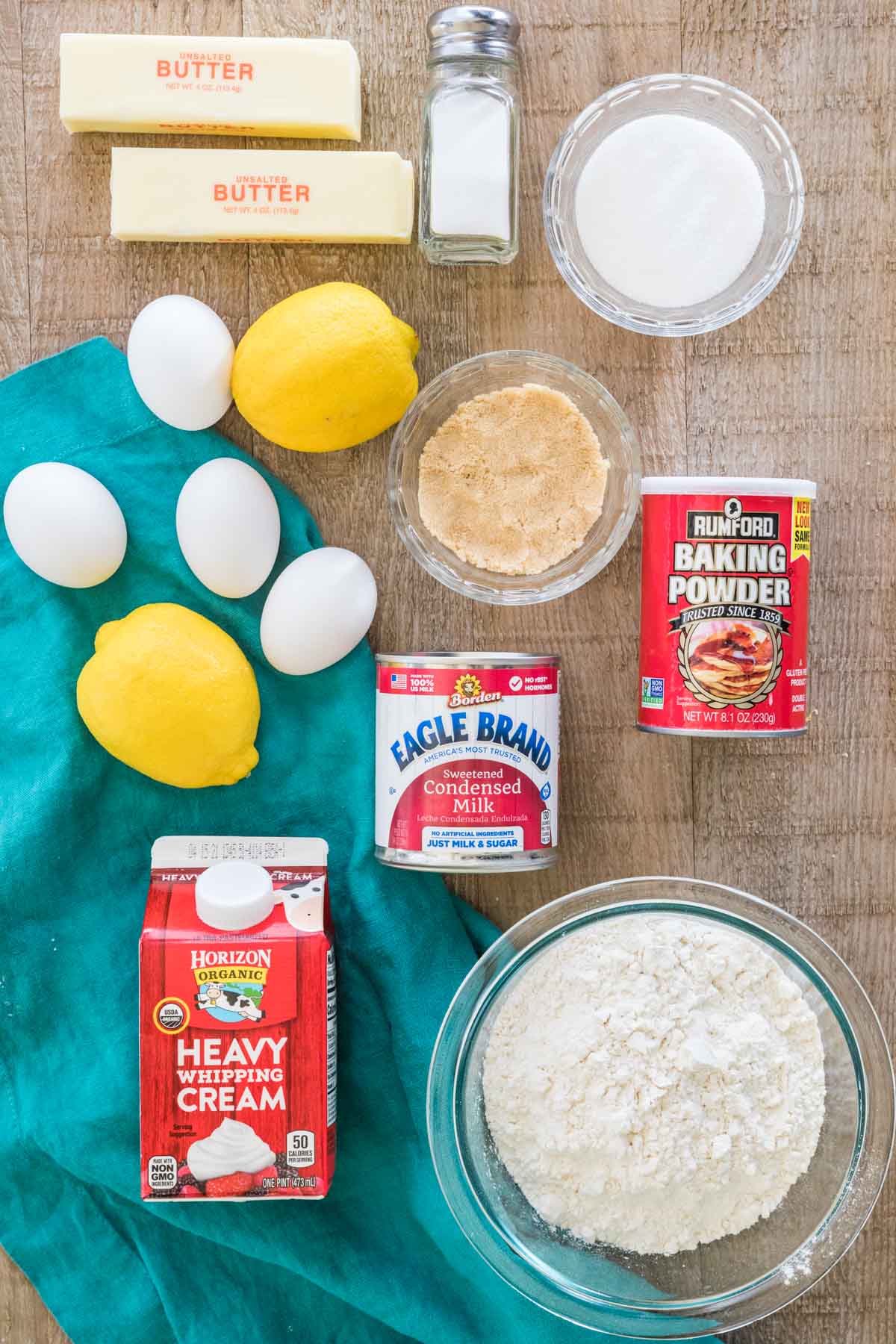 Butter, salt, granulated sugar, eggs, lemons, brown sugar, baking powder, sweetened condensed milk, heavy whipping cream, and flour.