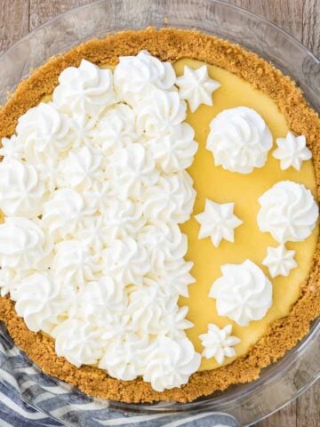 Overhead shot of a finished lemon pie decorate with homemade whipped cream.