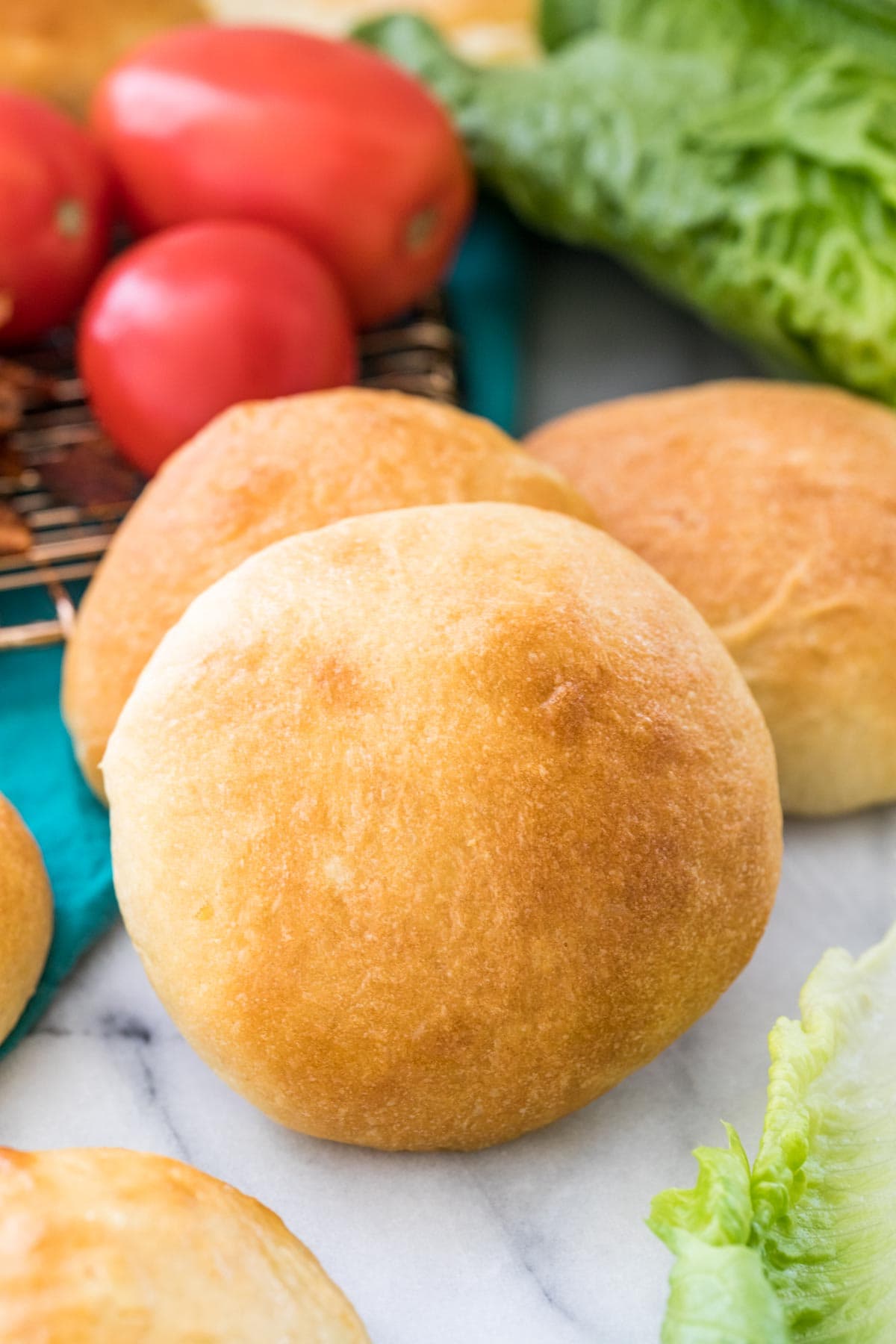 potto bun propped up on another bun with vegetables in background