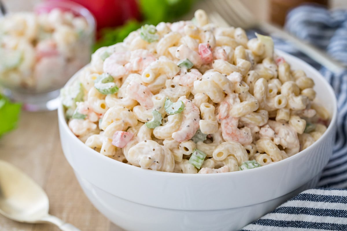 Closeup of shrimp pasta salad in a white bowl