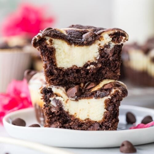a chocolate cheesecake muffin cut in half and stacked on top of itself to show creamy cheesecake center.