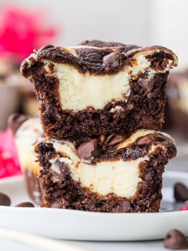a chocolate cheesecake muffin cut in half and stacked on top of itself to show creamy cheesecake center.