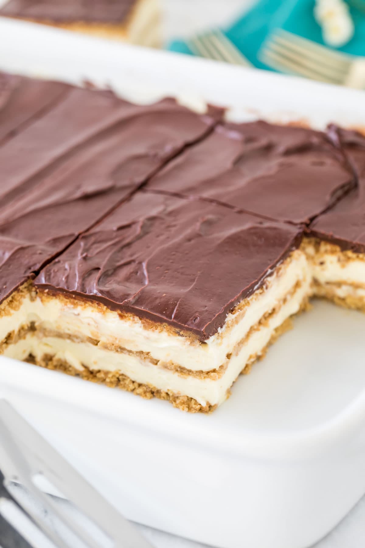 Sliced eclair cake in white rectangular baking dish