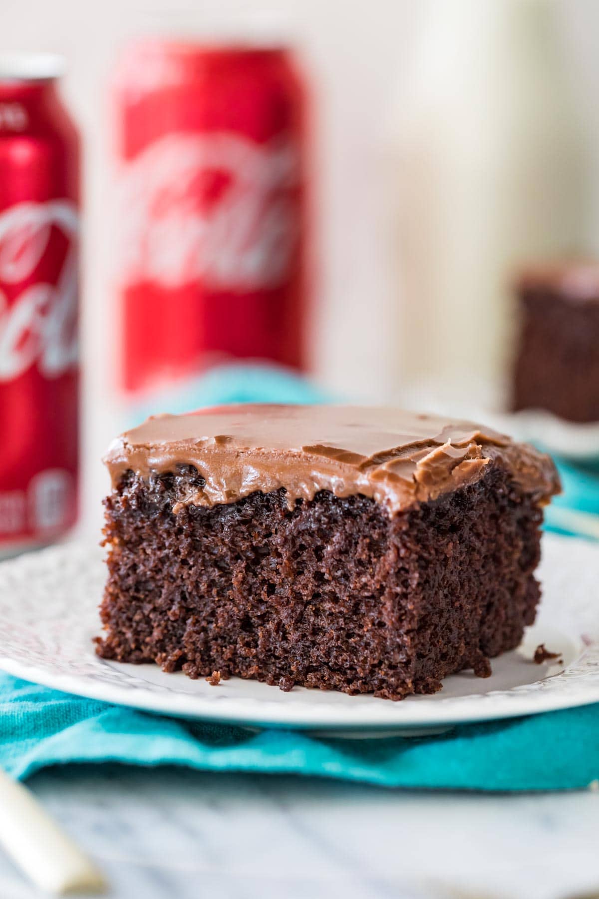 Close-up view of square piece of coca cola cake on white plate