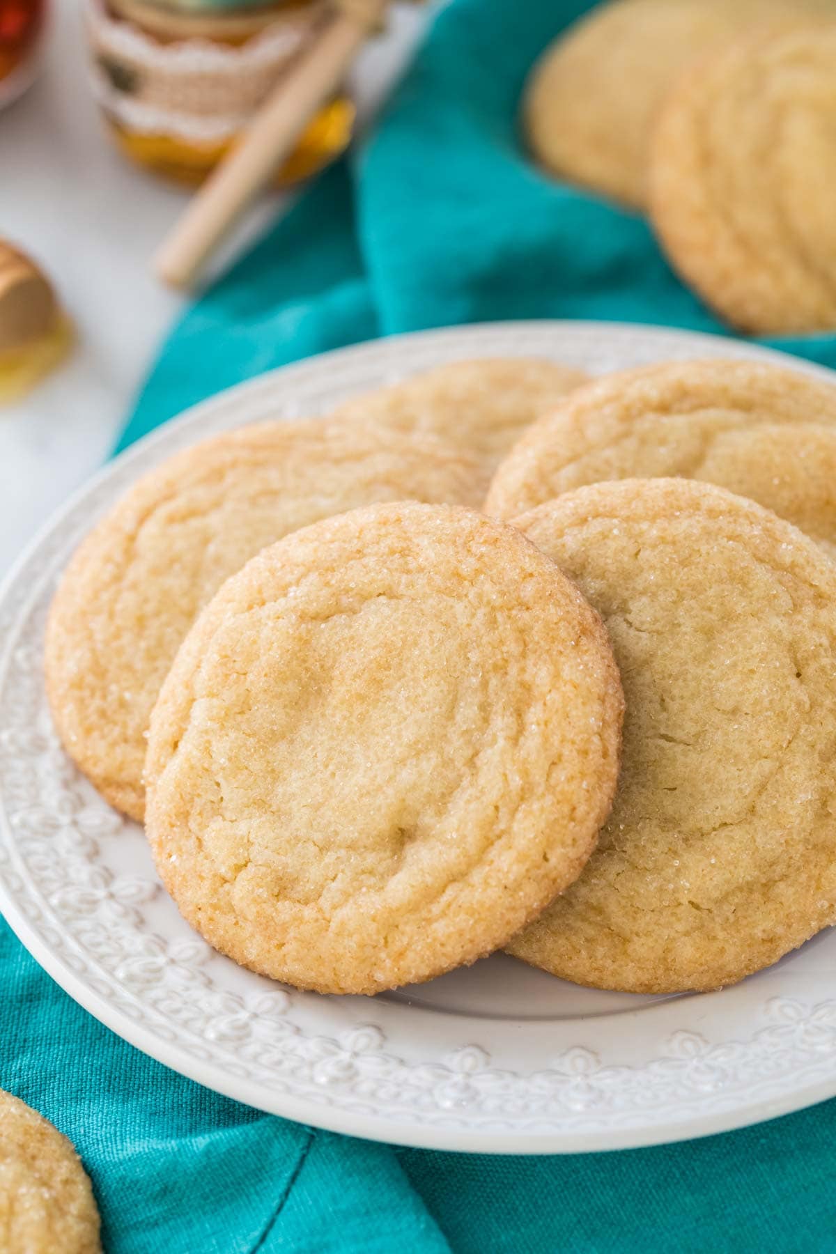 honey cookies on a white plate with teal linen in background