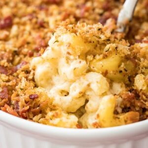 close-up view of bacon mac and cheese topped with crispy panko in white casserole dish