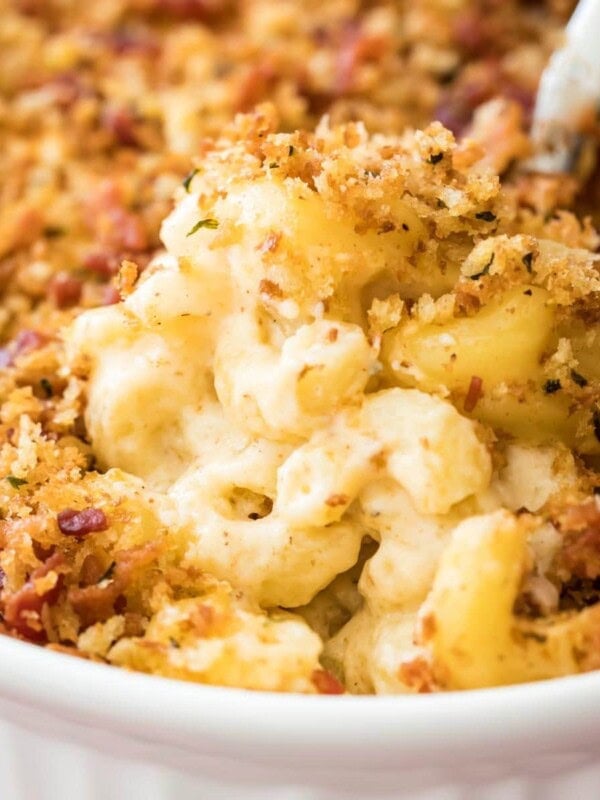 close-up view of bacon mac and cheese topped with crispy panko in white casserole dish