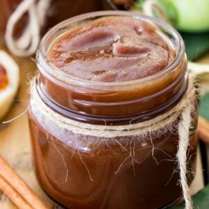 Rich brown apple butter recipe in a glass jar tied with twine