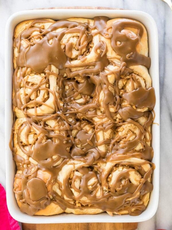 Baking dish full of caramel-glazed apple cinnamon rolls