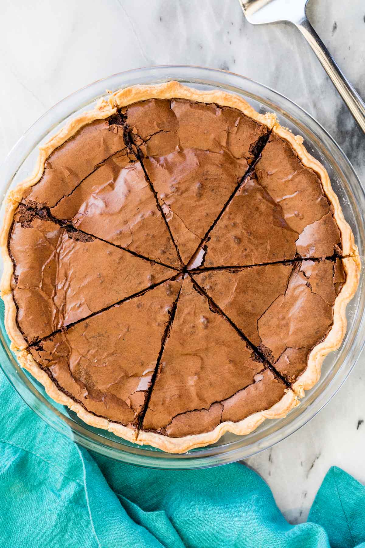 overhead view of a chocolate chess pie cut into eight pieces