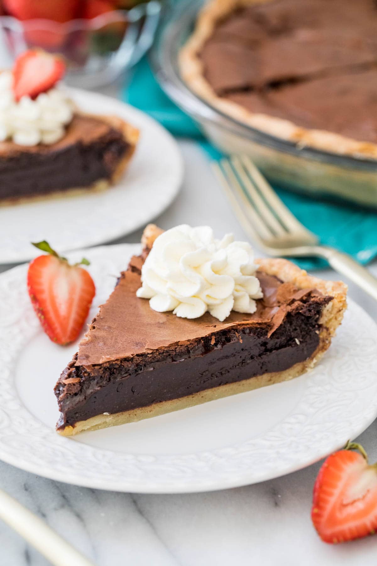 slice of chocolate chess pie topped with whipped cream