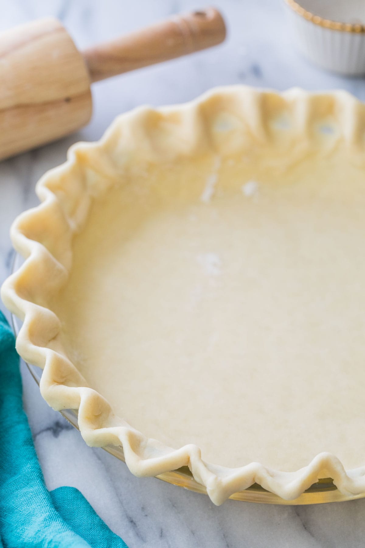 close-up view of unbaked homemade pie crust with fluted edge