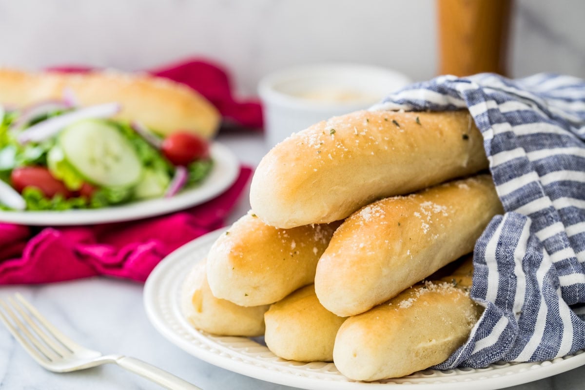 stacked pile of golden brown breadsticks