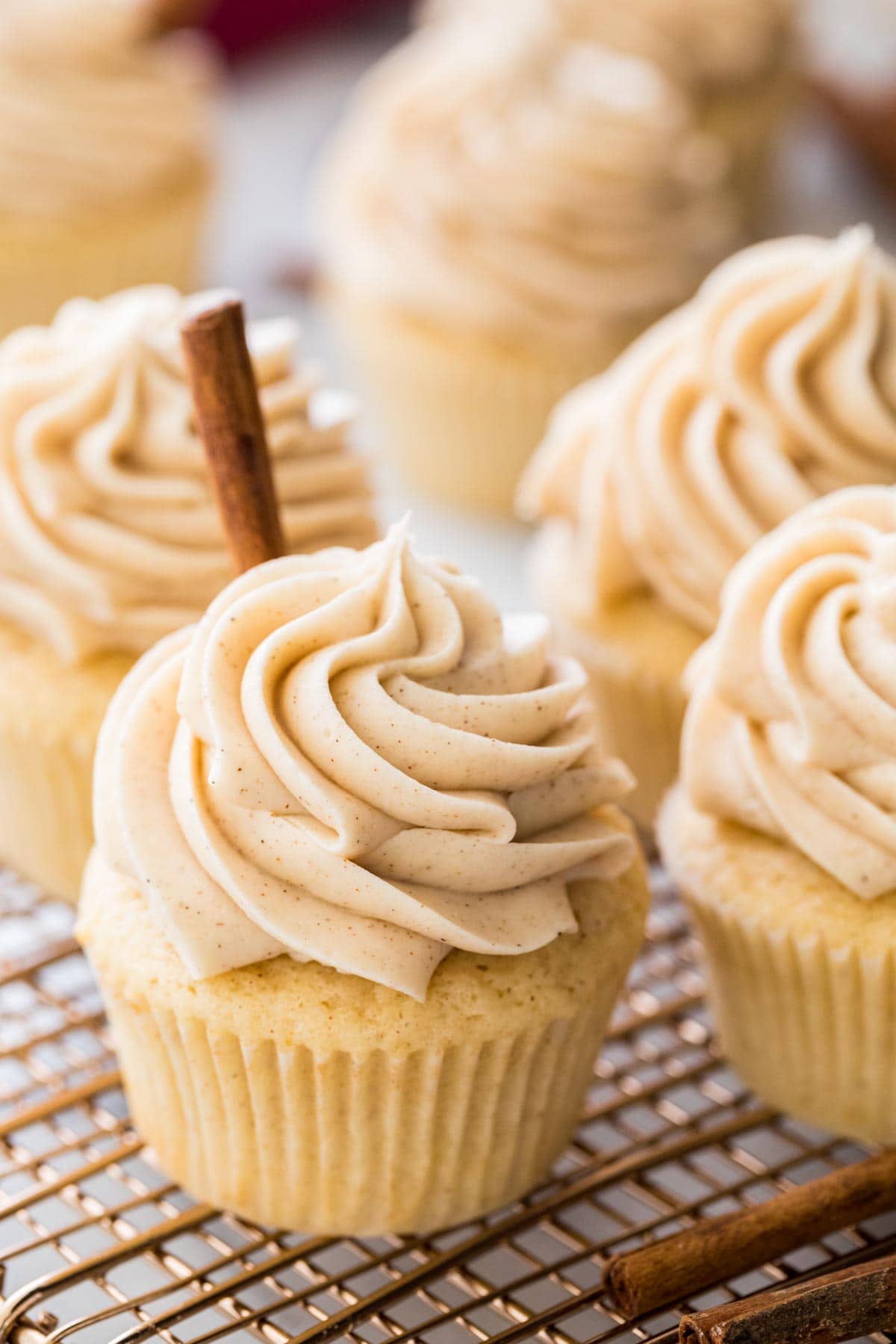 frosted snickerdoodle cupcakes on cooling rack