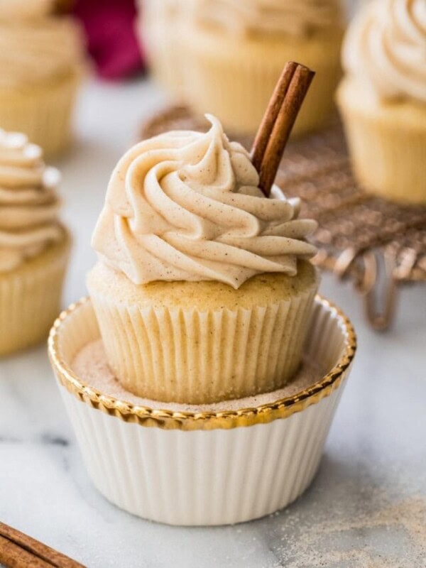 snickerdoodle cupcake resting in decorative dish of cinnamon sugar