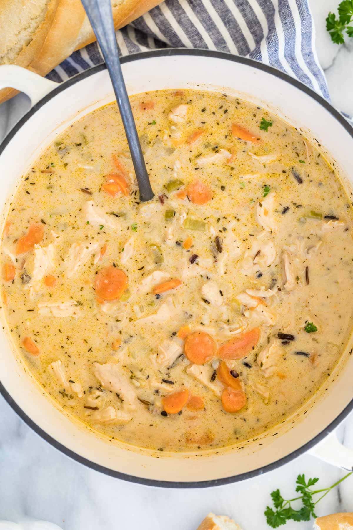 overhead view of white dutch oven full of chicken and rice soup