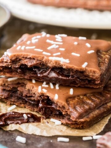 Two halves of a homemade chocolate pop tart stacked on top of each other to show the chocolate filled center