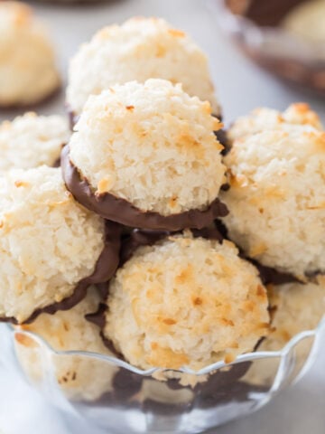 clear glass bowl full of chocolate dipped coconut macaroons