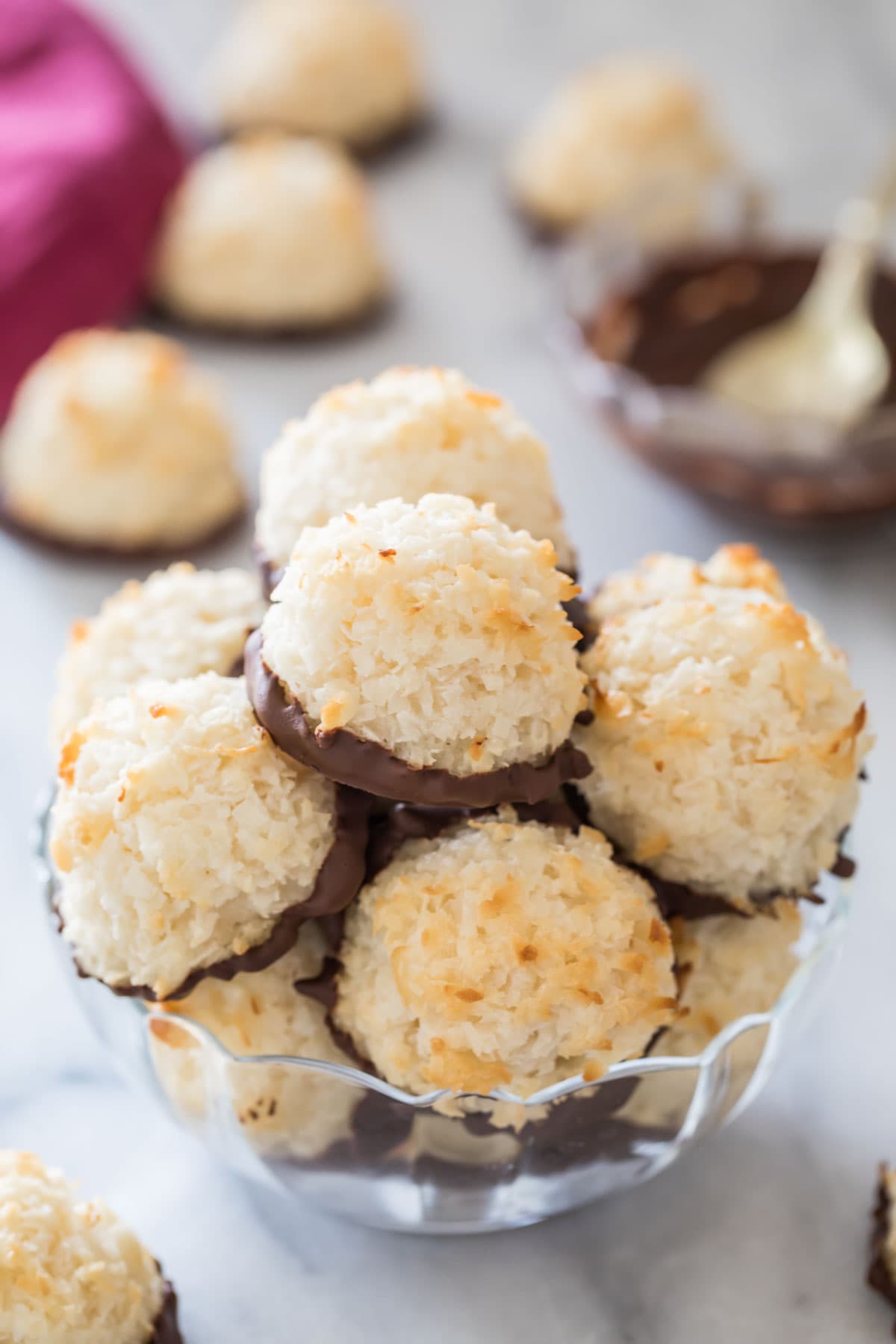 clear glass bowl full of chocolate dipped coconut macaroons