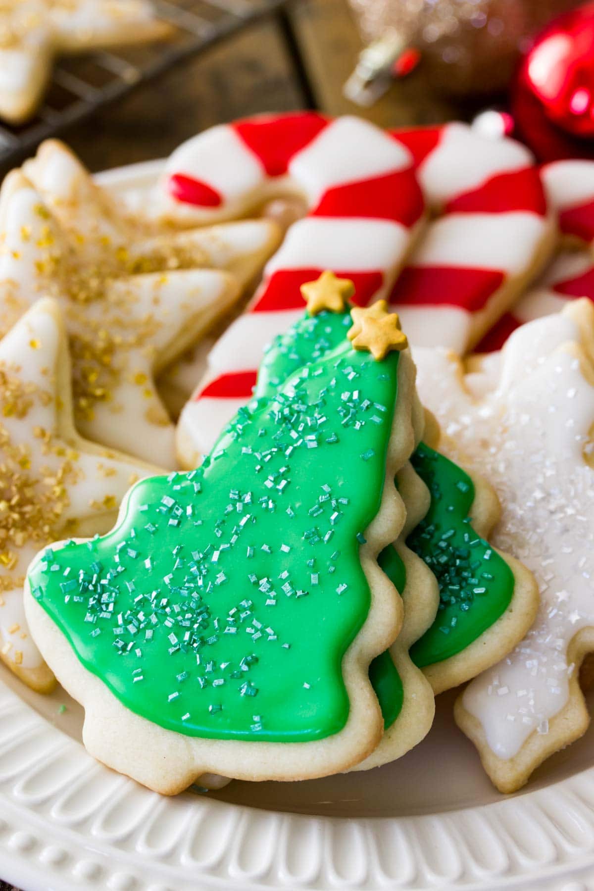 Plate of Christmas sugar cookies shaped and decorated as stars, candy canes, snowflakes and christmas trees