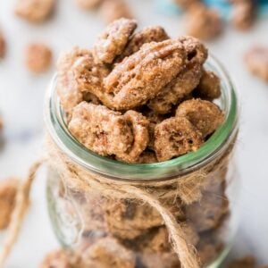 glass jar tied with twine filled with candied pecans