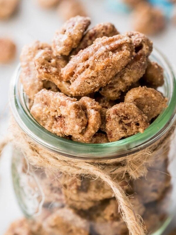 glass jar tied with twine filled with candied pecans