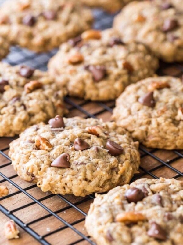 rows of cowboy cookies studded with chocolate chips, coconut, and pecan on black metal cooling rack