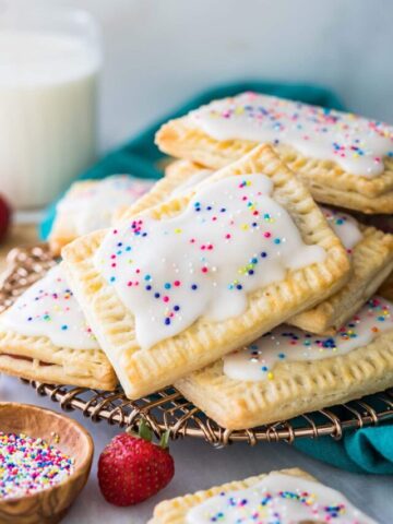 Stack of Homemade Strawberry Pop-Tarts on gold serving tray