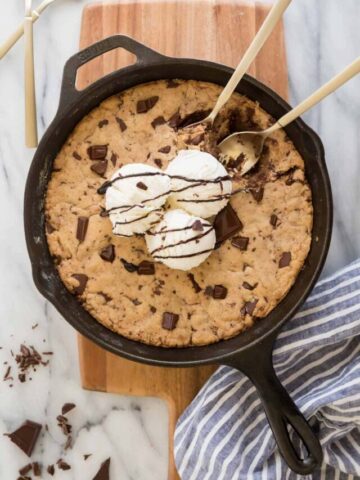 pizookie in skillet with three scoops of ice cream