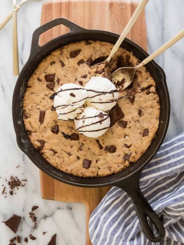 pizookie in skillet with three scoops of ice cream