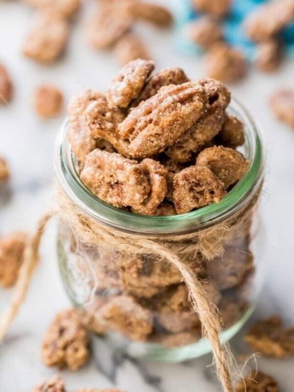 glass jar tied with twine filled with candied pecans