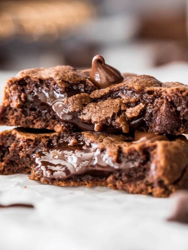 two halves of a chocolate fudge cookie stacked to show its soft, fudgy center