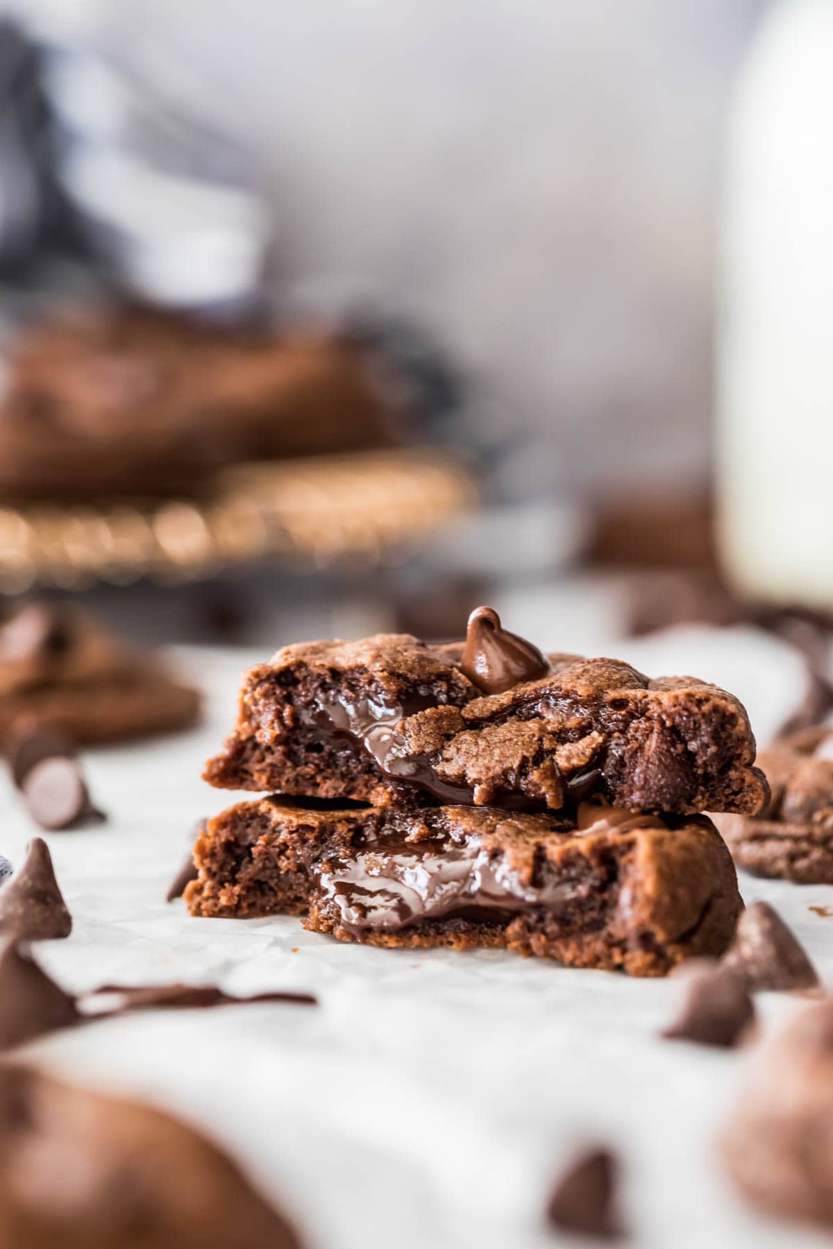 two halves of a chocolate fudge cookie stacked to show its soft, fudgy center