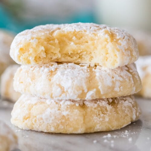 close-up view of three gooey butter cookies stacked on top of each other, with the top cookie missing a bite