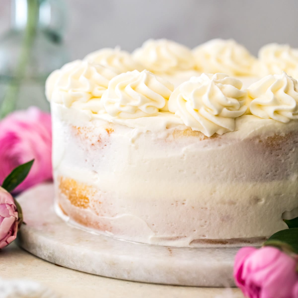 lightly frosted lemon cake consisting of two layers of white cake filled with lemon curd