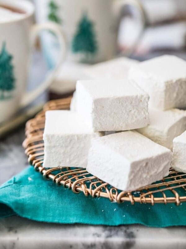 homemade marshmallows stacked on top of gold serving tray