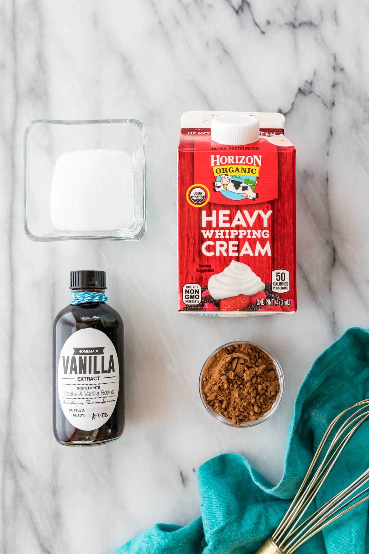 overhead view of ingredients including sugar, vanilla, cream, and cocoa powder