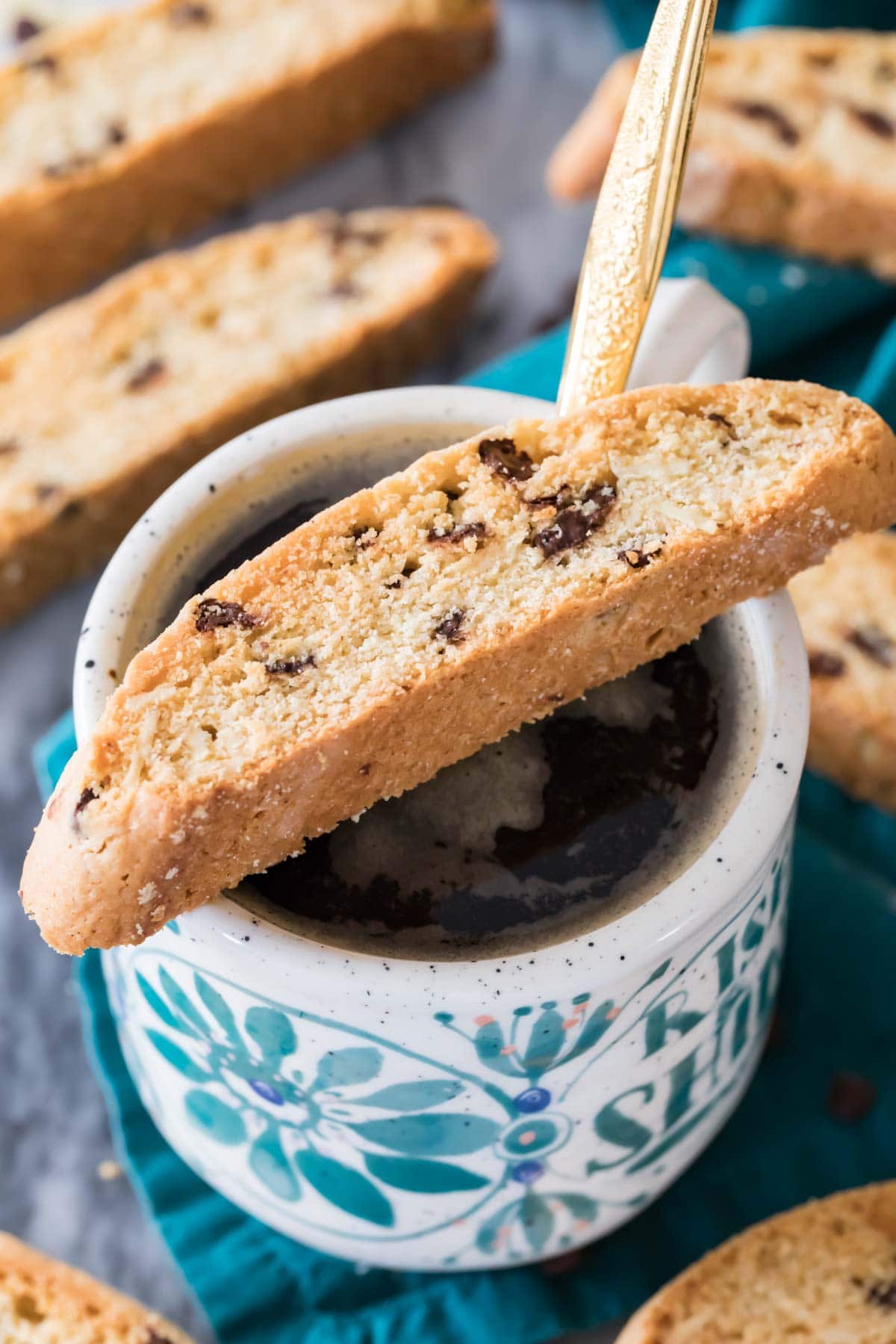 Italian biscotti cookie resting on a coffee cup full of coffee