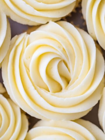 close-up overhead view of cupcakes with piped swirls with lemon frosting