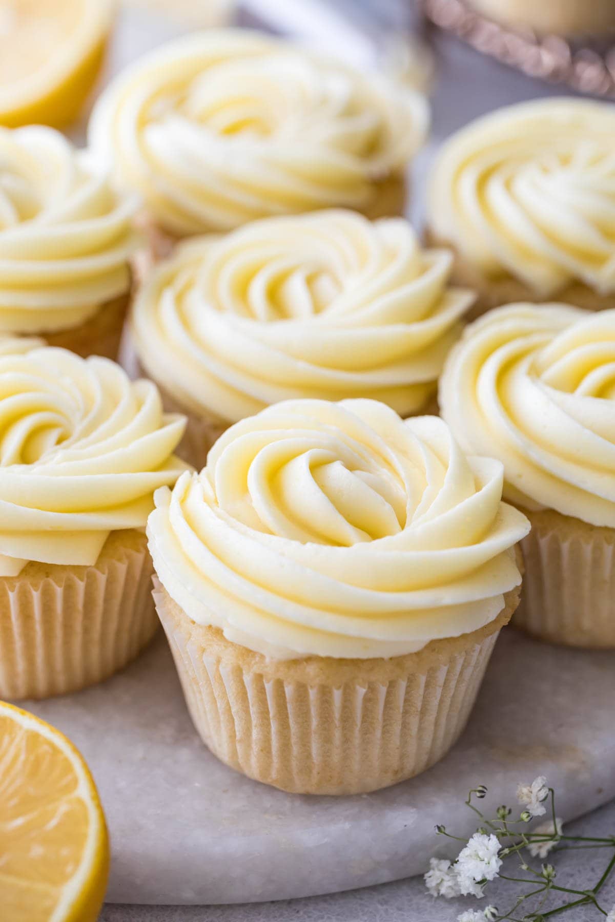 vanilla cupcakes topped with swirls of lemon frosting