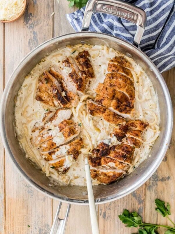overhead view of a stainless steel skillet full of creamy chicken pasta