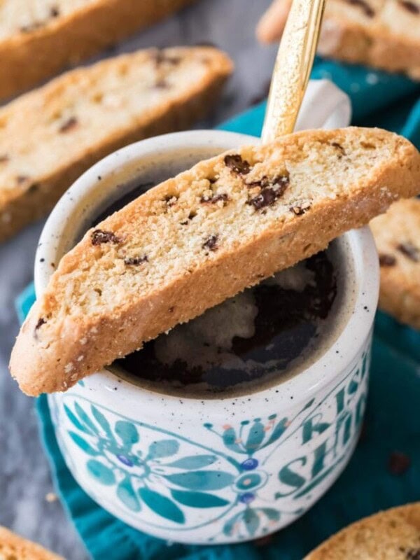 biscotti sitting on top of mug full of coffee