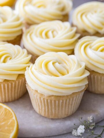 vanilla cupcakes topped with swirls of lemon frosting