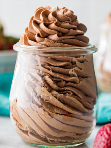 close-up view of chocolate whipped cream that's been piped into a small glass jar