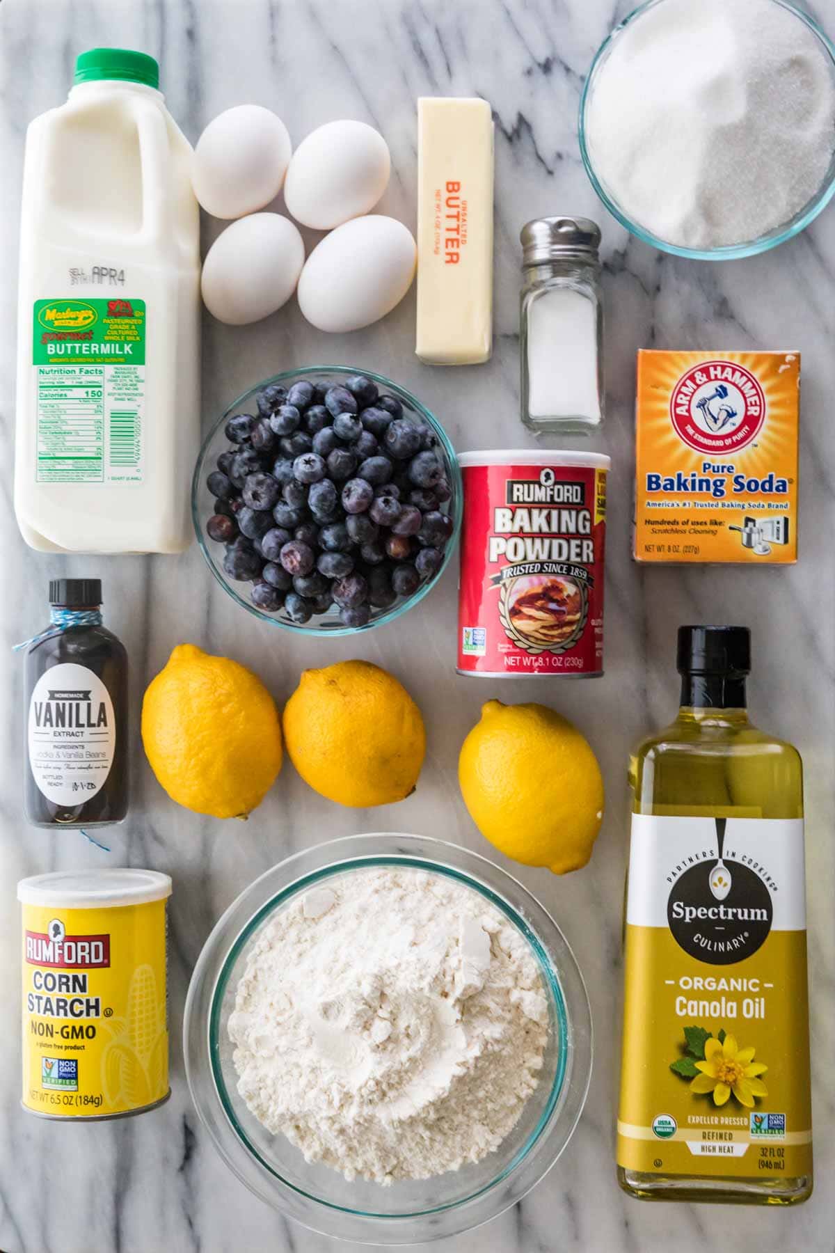 overhead view of ingredients including buttermilk, blueberries, and lemons, and many others