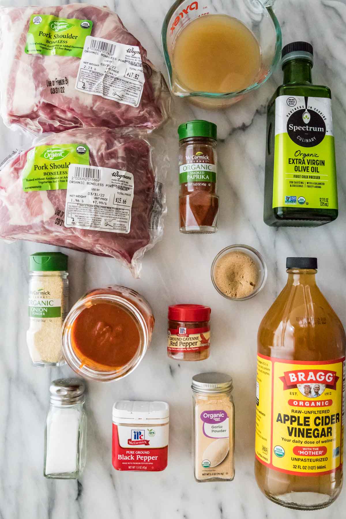 overhead view of ingredients including pork, barbecue sauce, vinegar, spices, and more