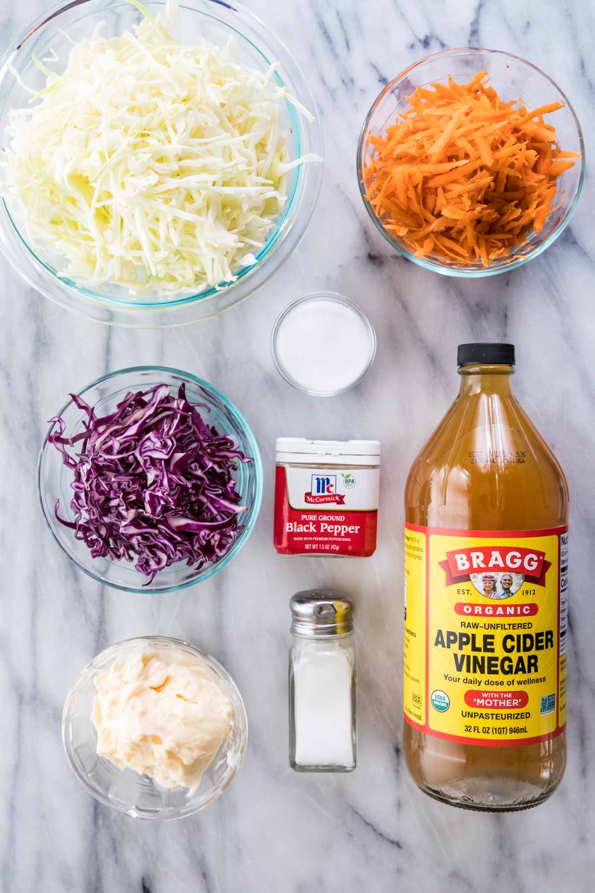 overhead view of ingredients including cabbage, carrots, vinegar, mayo, and more