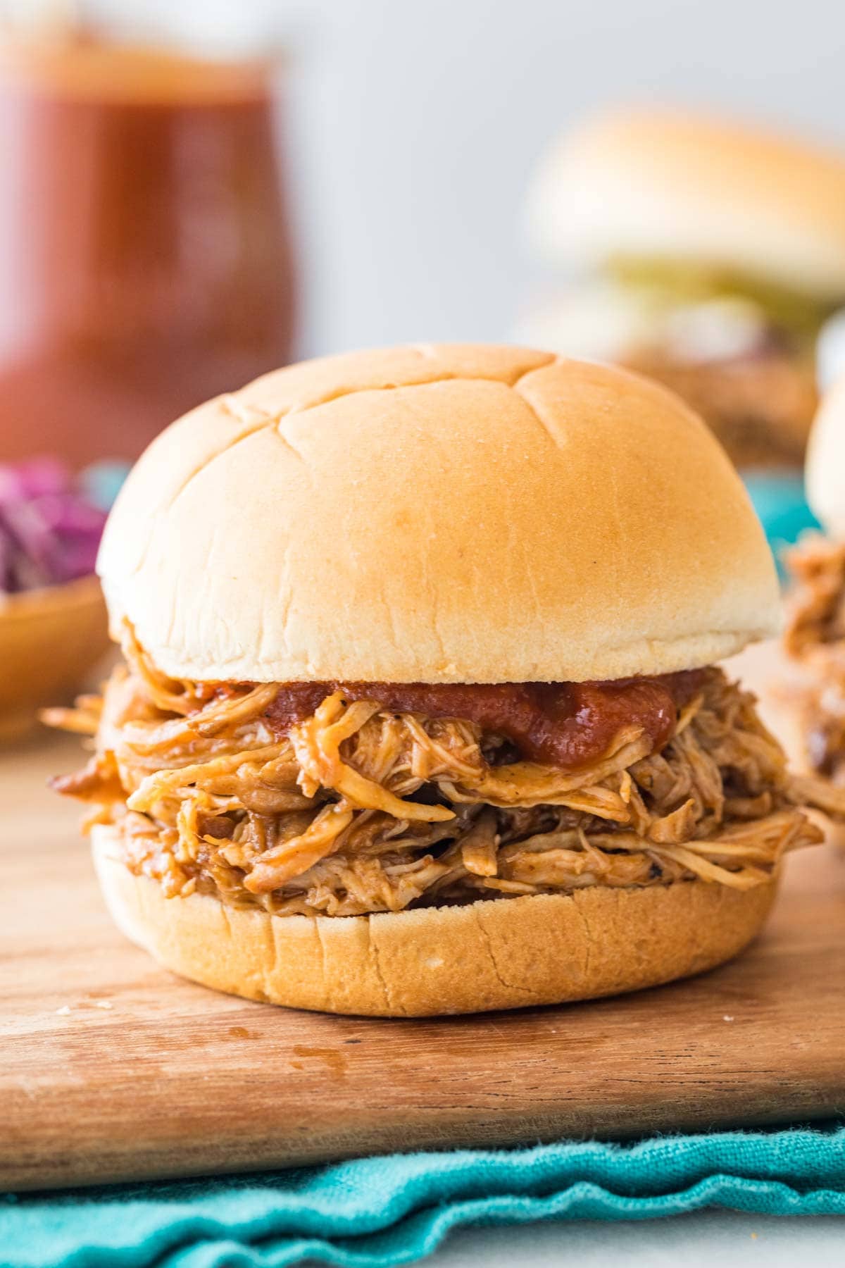 BBQ pork sandwich on a wood cutting board